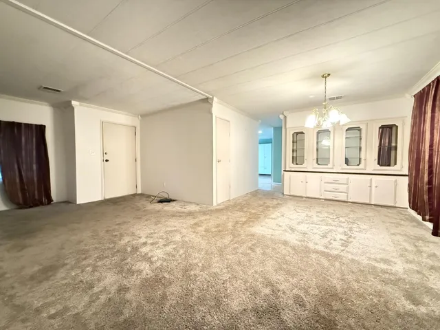 an empty room with a kitchen