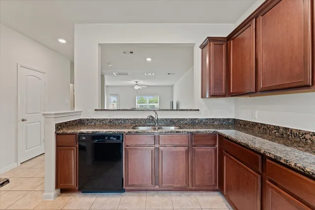 a kitchen with a sink and a stove top oven