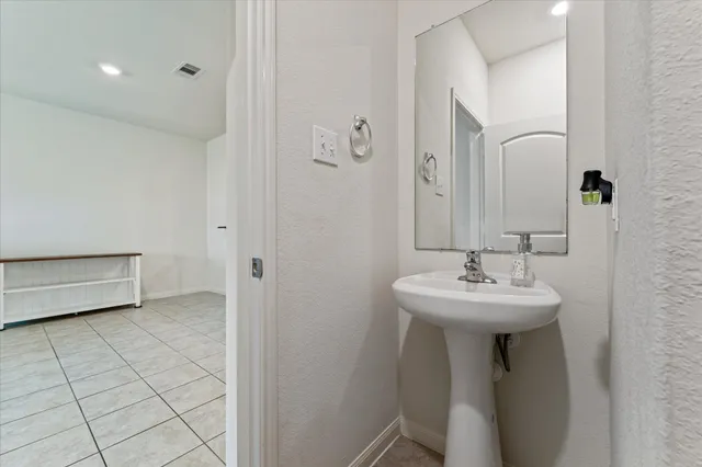 a bathroom with a sink a mirror and toilet