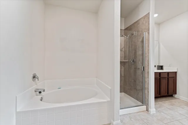 a white bath tub sitting in a bathroom and shower