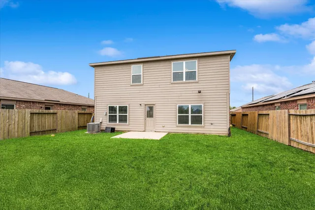 a backyard of a house with table and chairs