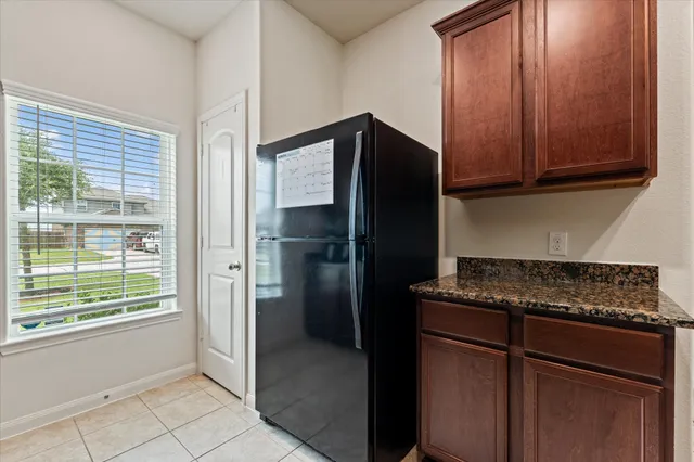 a kitchen with a refrigerator stove and cabinets