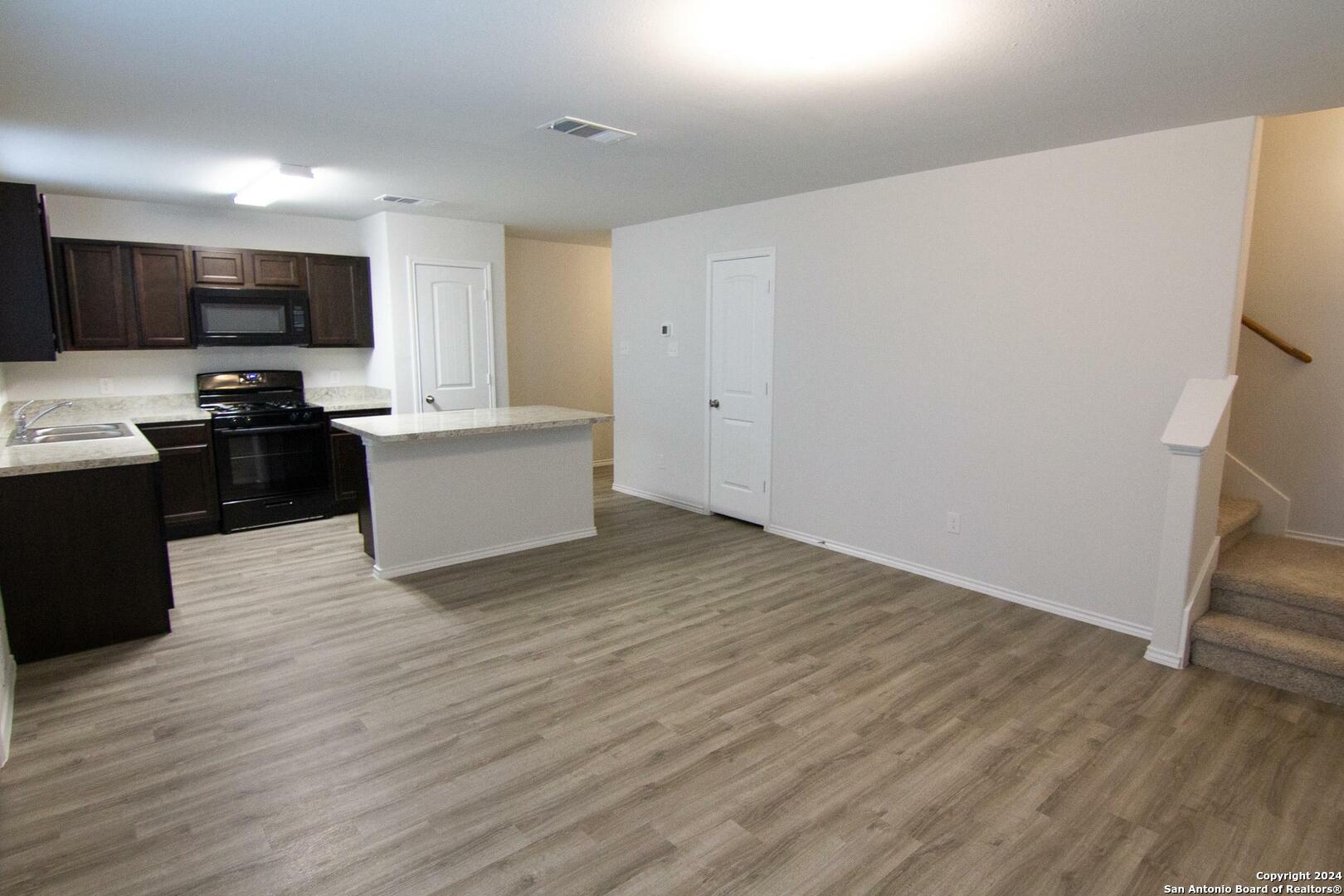 10706 Apple Pie Road San Antonio, TX 78224 - Photo 7 of 14 a view of a kitchen with microwave and cabinets
