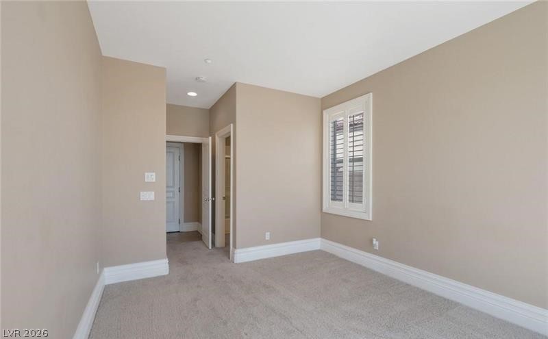 3 Tall Ruff Drive Las Vegas, NV 89148 - Photo 27 of 54 Well-appointed bedroom with plush carpeting, recessed lighting, and elegant window shutters.