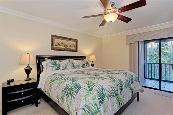 a bedroom with a bed and a mirror on dresser