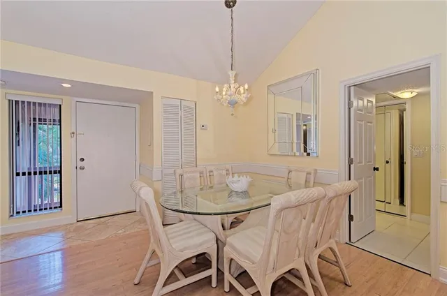 a view of a dining room with furniture and a chandelier