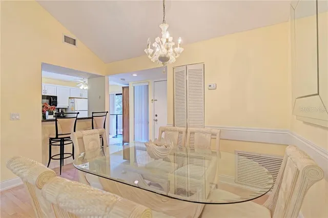 a kitchen with refrigerator and white cabinets