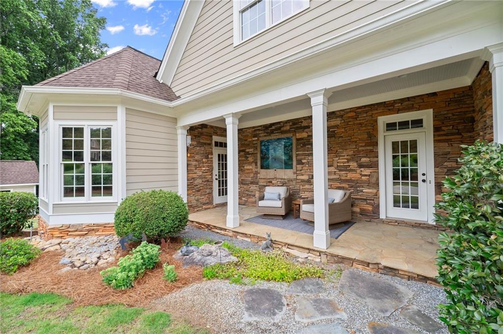 322 Edwards Brook Lane Canton, GA 30115 - Photo 5 of 99 front view of a house with a chairs and table in a patio