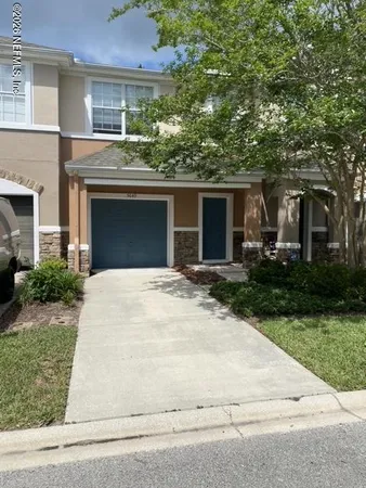 a front view of house with yard and trees