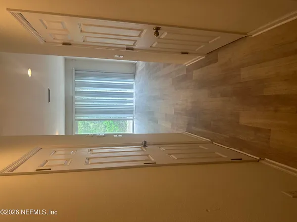 a view of an empty room with a window