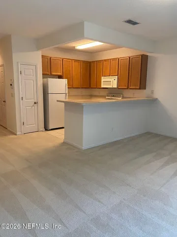 a view of kitchen and utility room