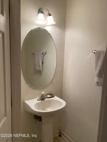 a bathroom with a sink and mirror