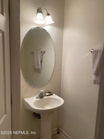 a bathroom with a sink and mirror