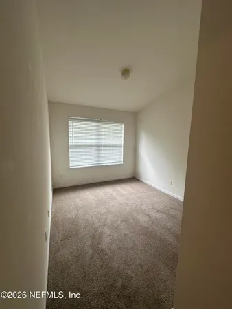 an empty room with a empty space and window