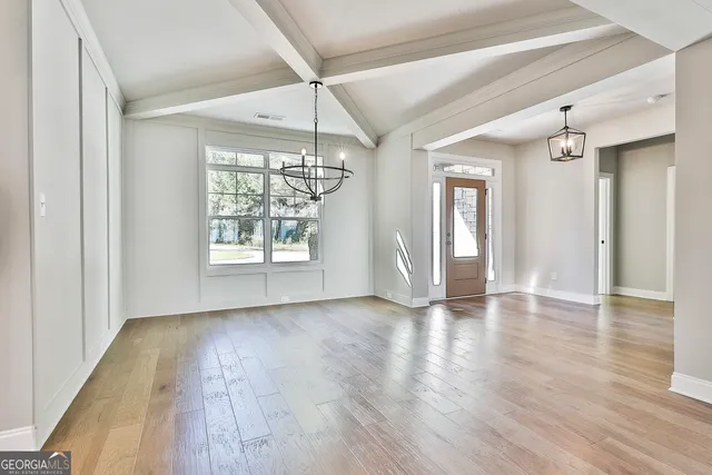 a view of empty room with wooden floor and fireplace