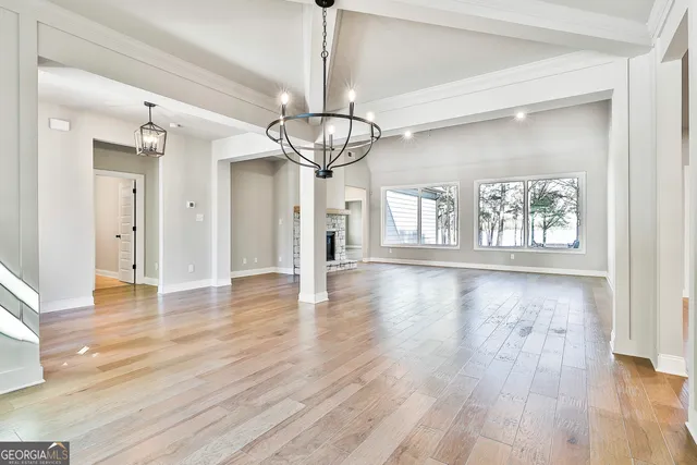 a view of empty room with wooden floor
