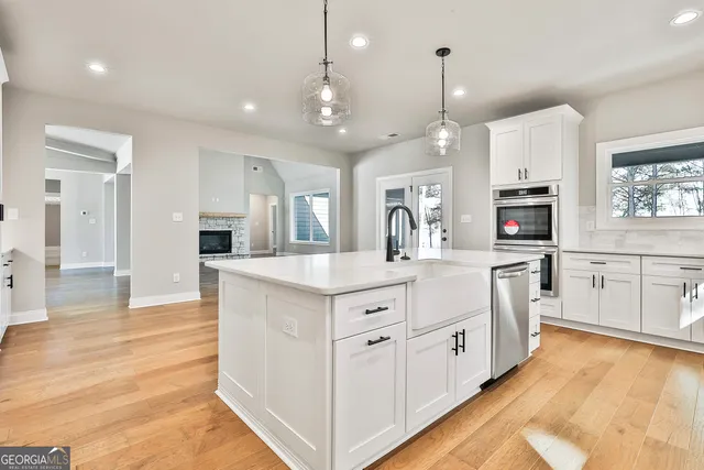 a spacious bathroom with double sink and a mirror