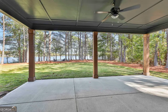 a view of lake with wooden stairs and palm trees