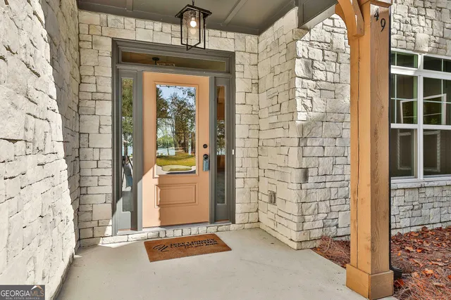 a view of empty room with wooden floor and window