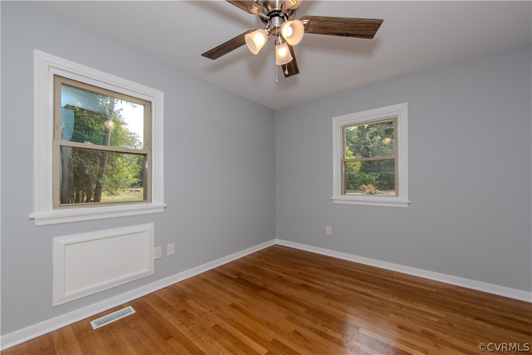 8205 Buffin Road Henrico, VA 23231 - Photo 17 of 42 a view of empty room with wooden floor and fan