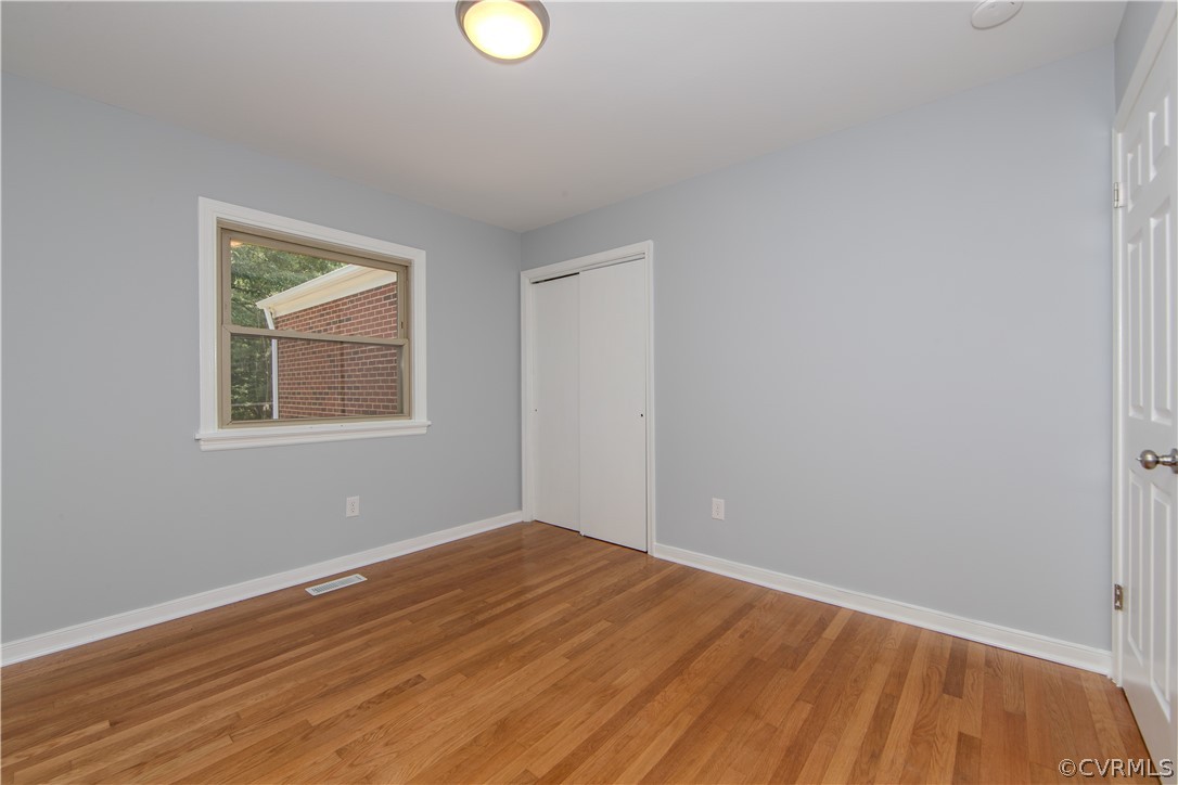 8205 Buffin Road Henrico, VA 23231 - Photo 19 of 42 an empty room with wooden floor and windows