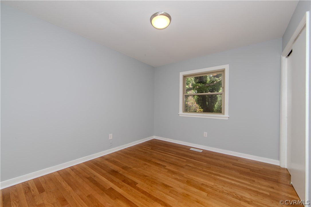 8205 Buffin Road Henrico, VA 23231 - Photo 20 of 42 an empty room with wooden floor and windows