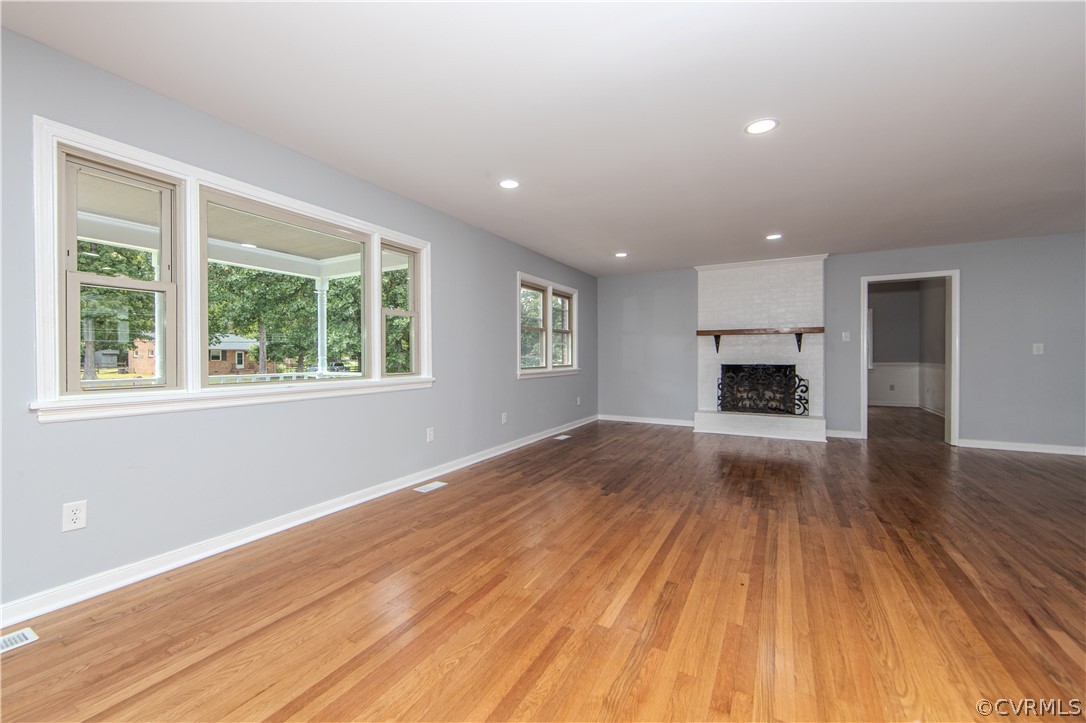 8205 Buffin Road Henrico, VA 23231 - Photo 4 of 42 a view of empty room with a fireplace and wooden floor