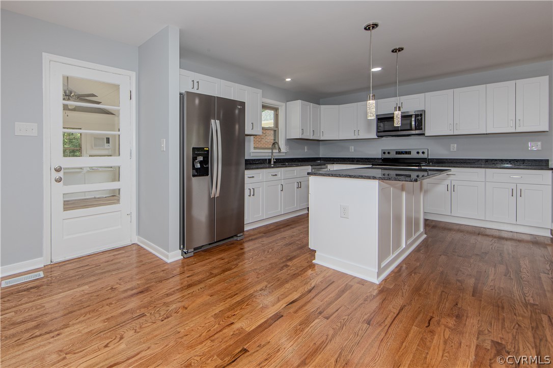 8205 Buffin Road Henrico, VA 23231 - Photo 6 of 42 a kitchen with stainless steel appliances granite countertop a refrigerator and a stove top oven