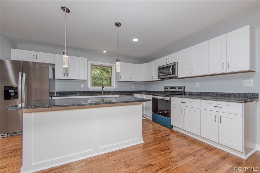 8205 Buffin Road Henrico, VA 23231 - Photo 7 of 42 a kitchen with stainless steel appliances granite countertop a stove a sink dishwasher a refrigerator and white cabinets with wooden floor