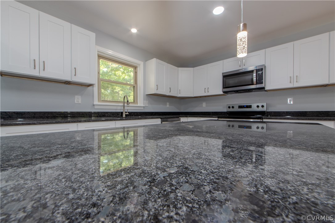 8205 Buffin Road Henrico, VA 23231 - Photo 8 of 42 a kitchen with granite countertop a sink a window and stainless steel appliances