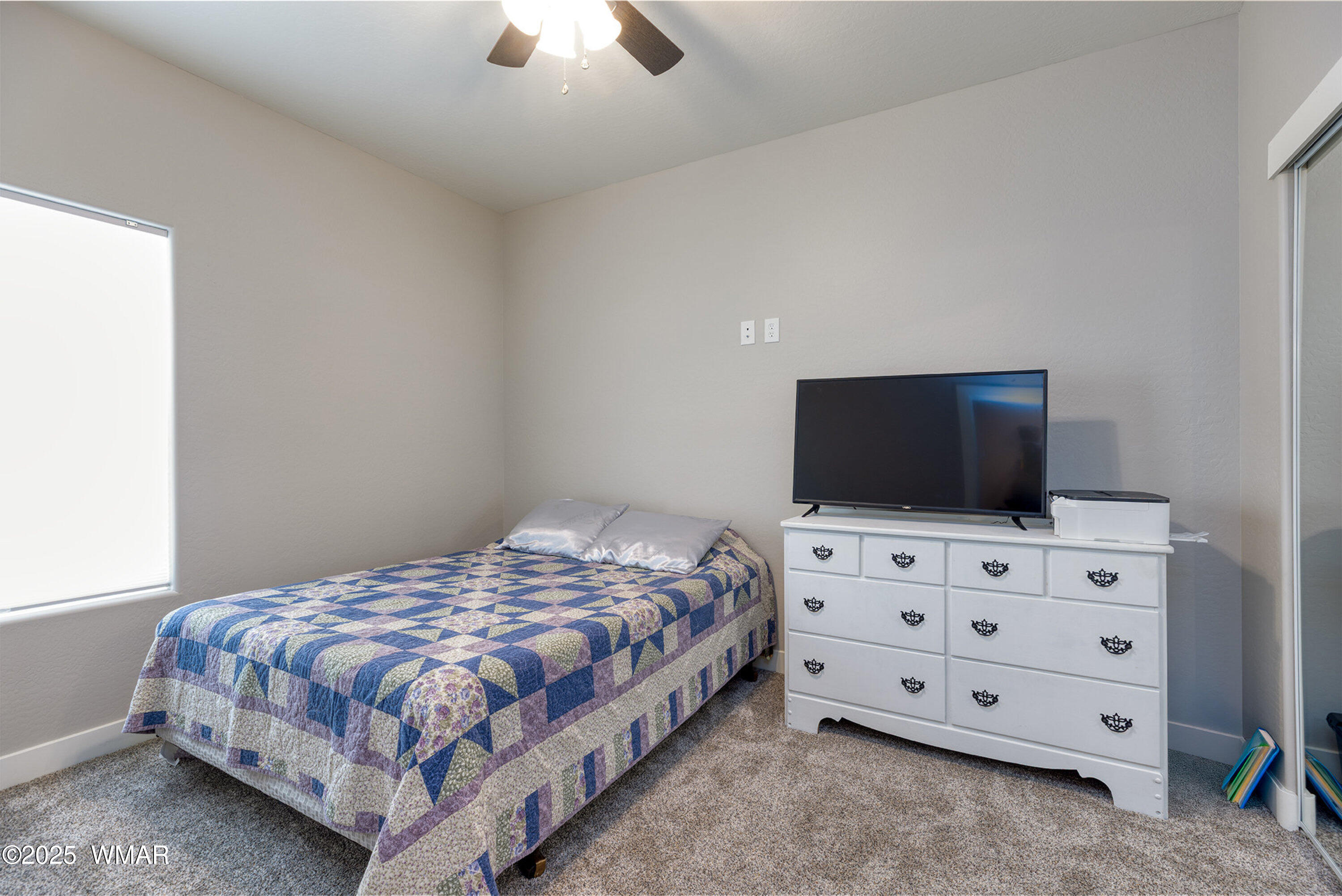799 Cobble Lane Taylor, AZ 85939 - Photo 13 of 34 a bedroom with a bed and a flat tv screen on dresser