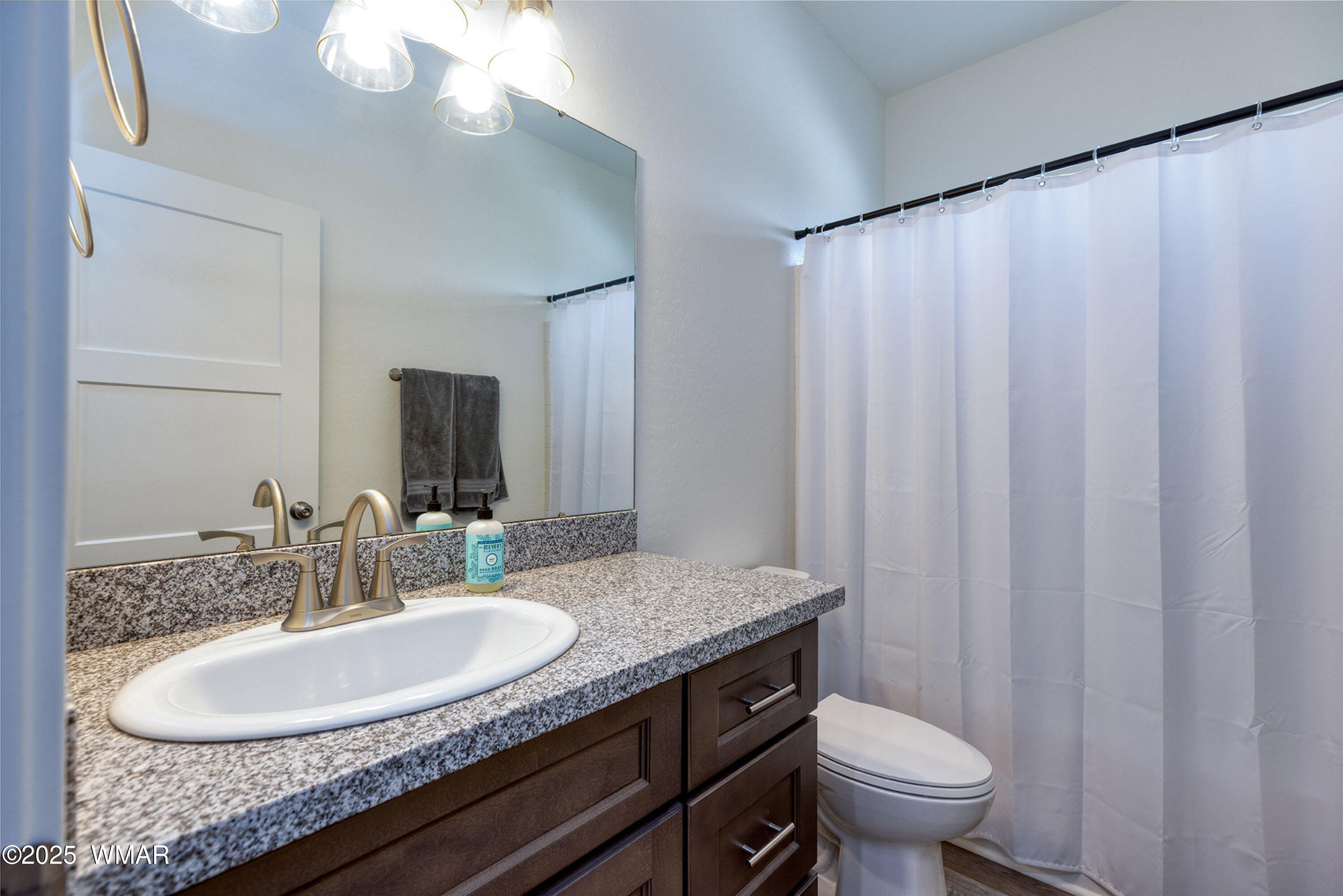 799 Cobble Lane Taylor, AZ 85939 - Photo 17 of 34 a bathroom with a granite countertop sink and a mirror with toilet