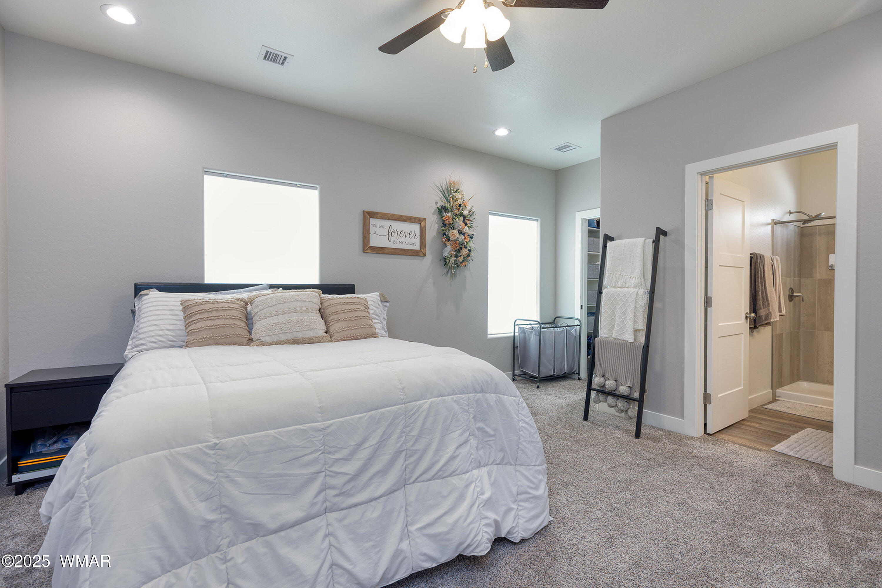 799 Cobble Lane Taylor, AZ 85939 - Photo 9 of 34 a spacious bedroom with a bed and a chandelier
