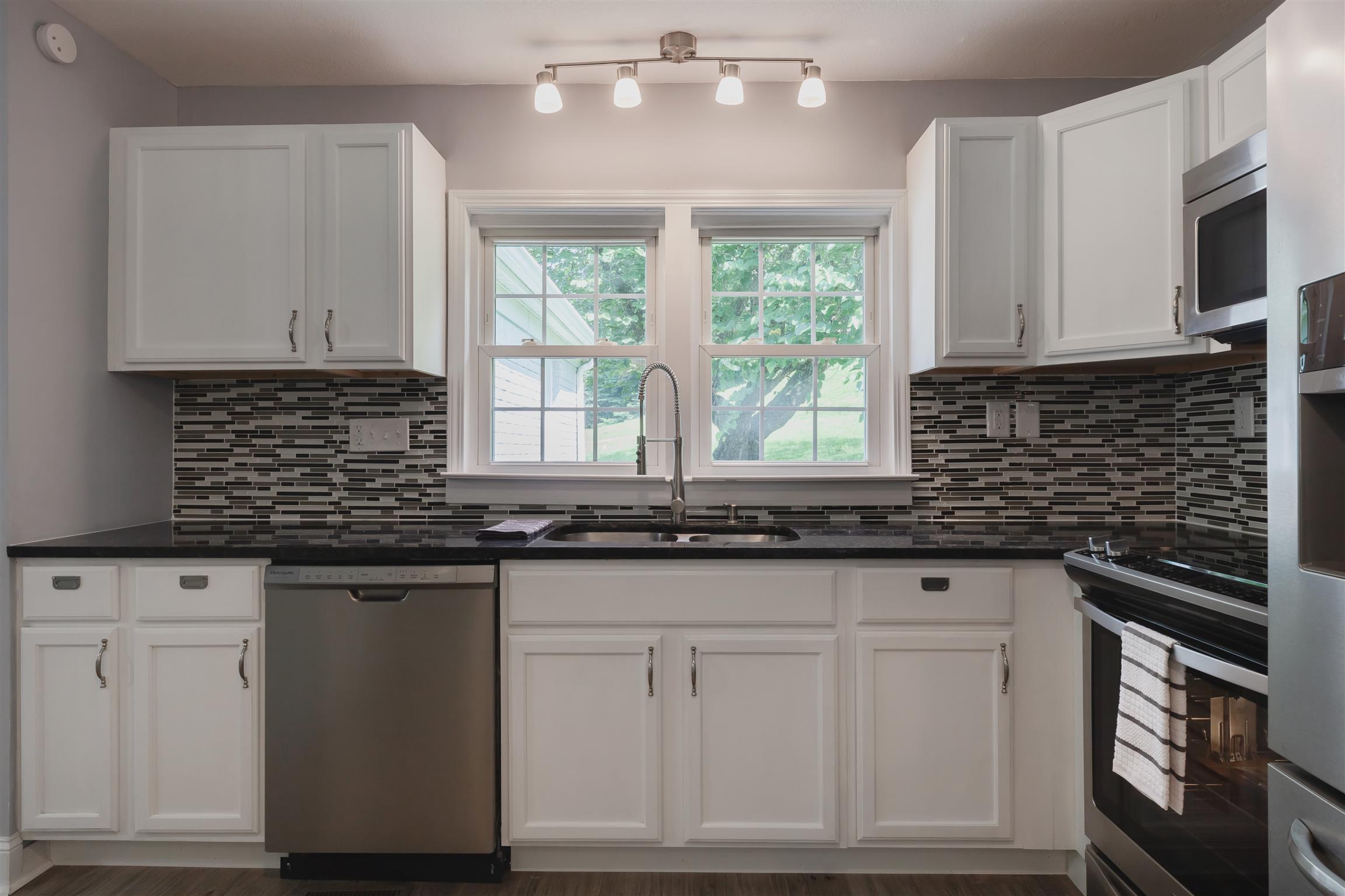 3128 Fly Road Santa Fe, TN 38482 - Photo 13 of 15 a kitchen with granite countertop white cabinets and a stainless steel appliances