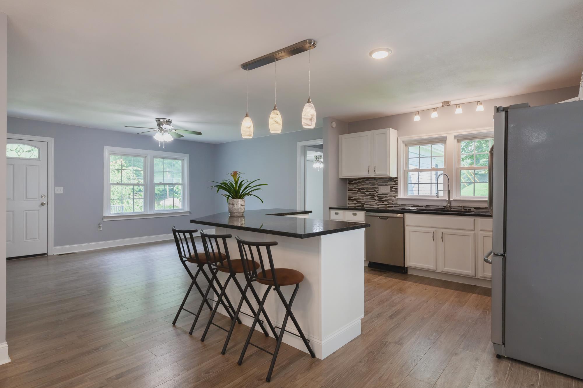 3128 Fly Road Santa Fe, TN 38482 - Photo 3 of 15 a kitchen with granite countertop white cabinets a counter and chairs