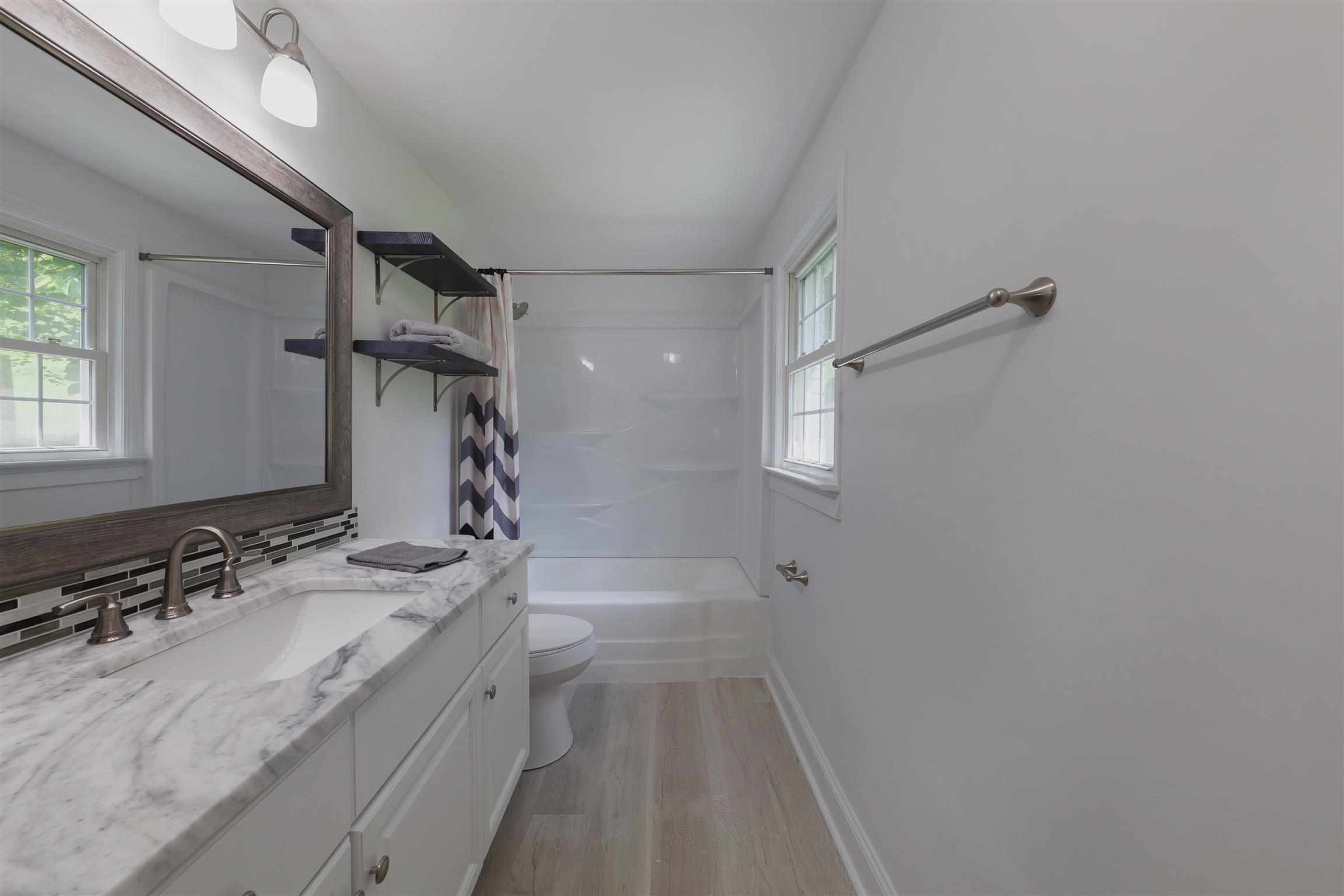 3128 Fly Road Santa Fe, TN 38482 - Photo 5 of 15 a bathroom with a sink a mirror and a shower
