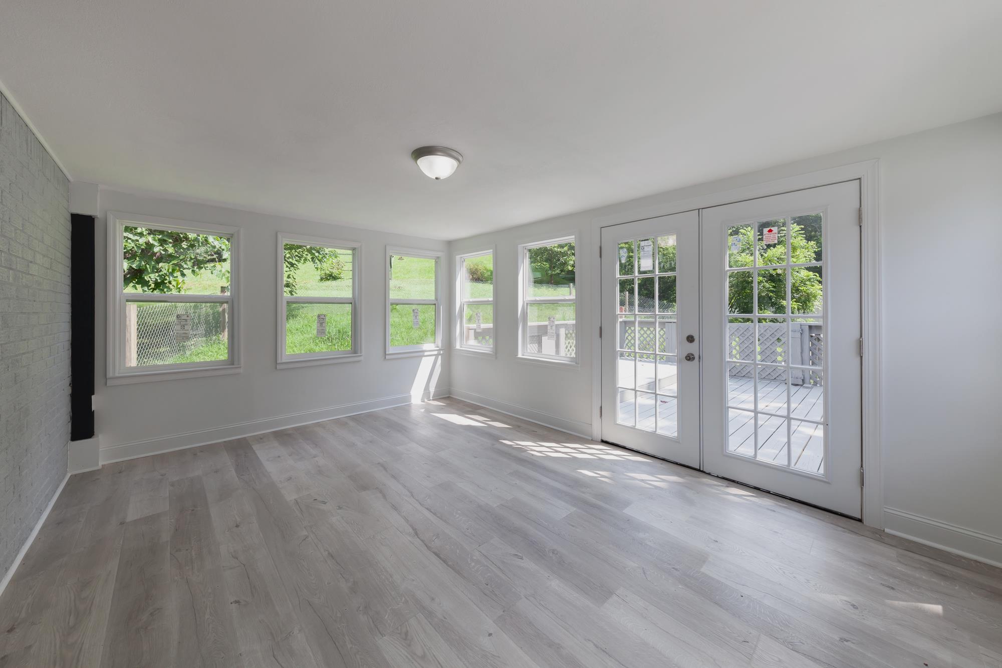 3128 Fly Road Santa Fe, TN 38482 - Photo 6 of 15 a view of an empty room with wooden floor and a window