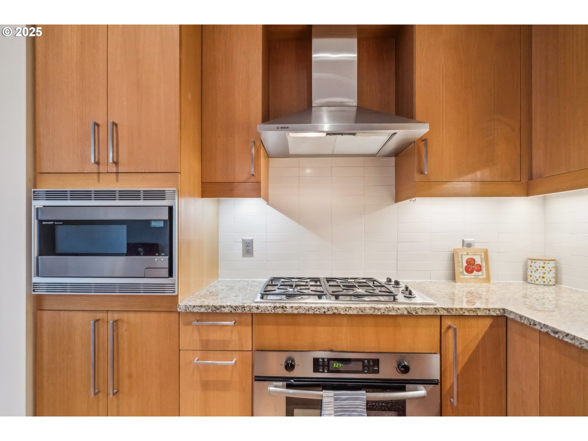 2351 Northwest Westover Road, Unit 315 Portland, OR 97210 - Photo 11 of 16 a kitchen with a stove and a microwave