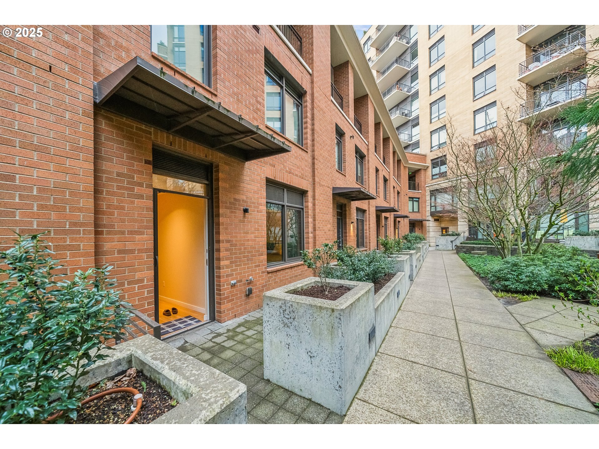 2351 Northwest Westover Road, Unit 315 Portland, OR 97210 - Photo 13 of 16 a view of a brick house with many windows