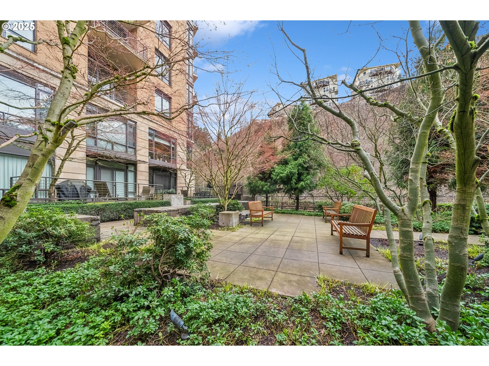 2351 Northwest Westover Road, Unit 315 Portland, OR 97210 - Photo 15 of 16 a backyard of a house with table and chairs