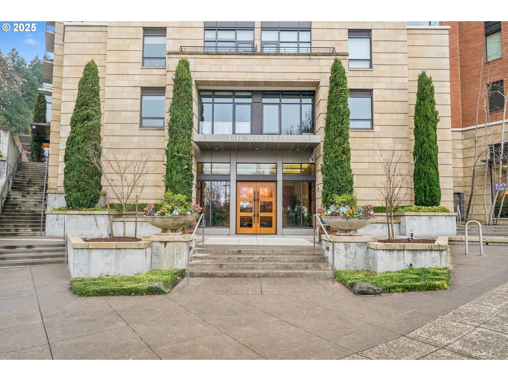 2351 Northwest Westover Road, Unit 315 Portland, OR 97210 - Photo 2 of 16 a front view of a house with a garden and plants