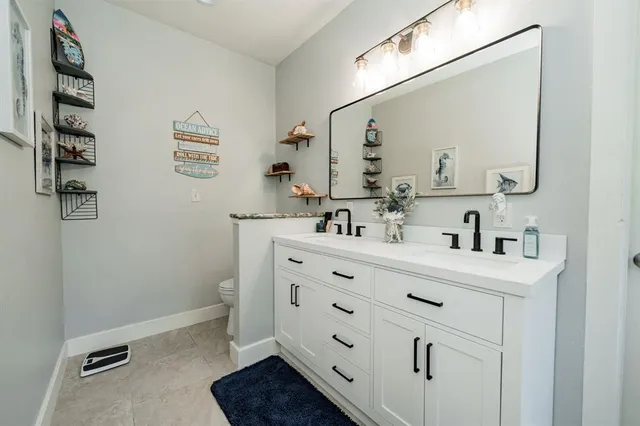 a bathroom with a tub sink and mirror