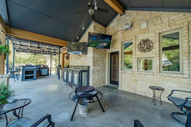 a view of a patio with table and chairs and potted plants
