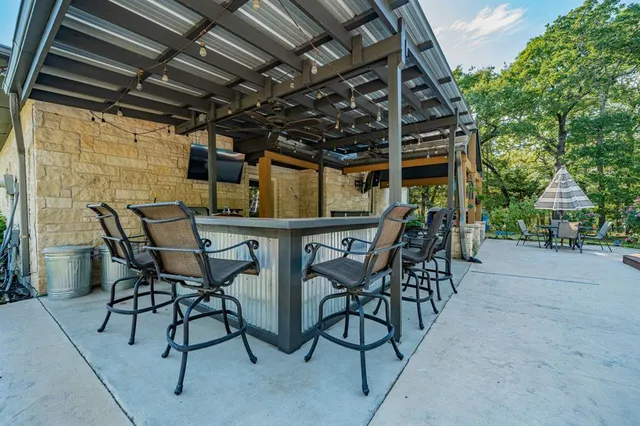 a view of a patio with table and chairs and potted plants