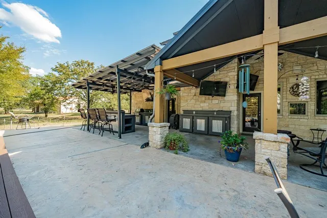 an aerial view of a house with a yard and lake view