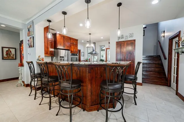 a dining room with furniture a rug and a clock
