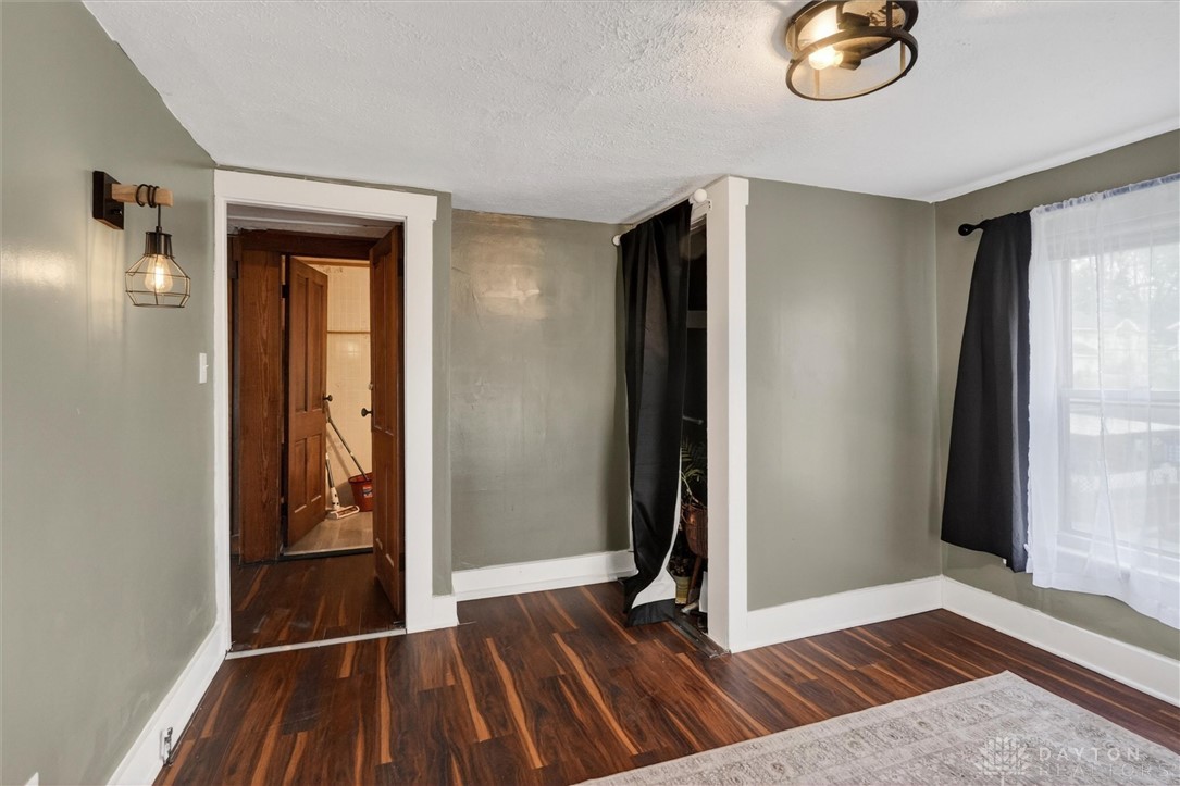 1726 Morgan Street Springfield, OH 45503 - Photo 25 of 30 This cozy bedroom features rich wood flooring, natural light, and ample space for relaxation.