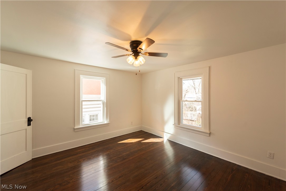 1022 North Howard Street Akron, OH 44310 - Photo 18 of 38 Bedroom 2 featuring ceiling fan, new double pane vinyl windows and dark hardwood flooring