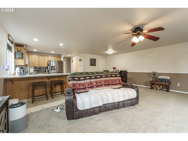 a living room with furniture and a pool table