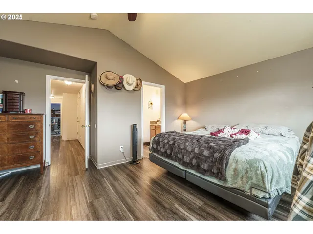 a living room with a bed furniture and a wooden floor